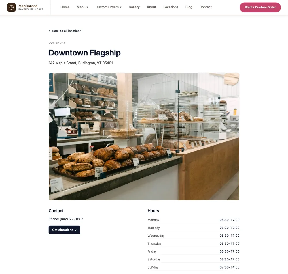 The Downtown Flagship location page on the Maplewood Bakehouse & Cafe demo site, showing its address, a photo, phone, Get directions and opening hours for every day